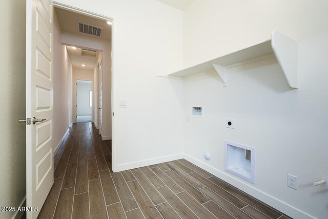 laundry room featuring hookup for a washing machine, electric dryer hookup, dark hardwood / wood-style flooring, and hookup for a gas dryer