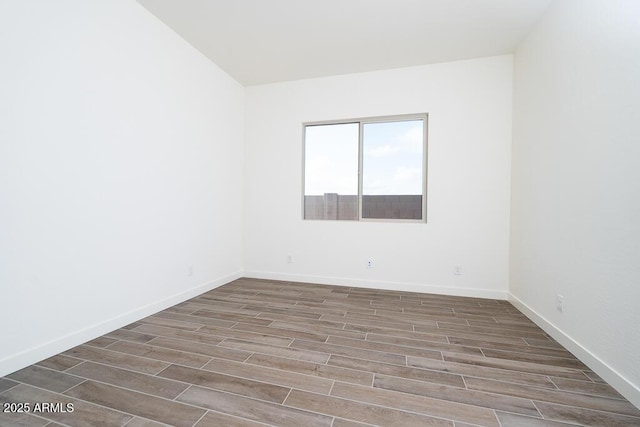 spare room with wood-type flooring