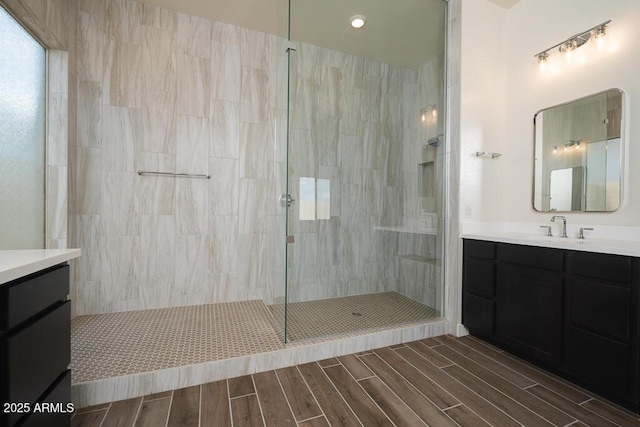 bathroom featuring tiled shower and vanity