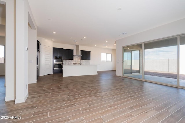 unfurnished living room with dark wood-type flooring