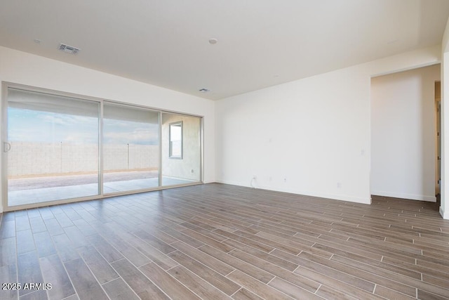 unfurnished room with hardwood / wood-style floors