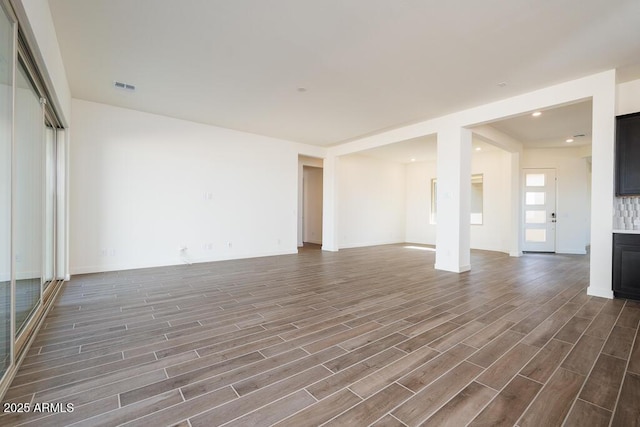 unfurnished living room featuring dark hardwood / wood-style floors