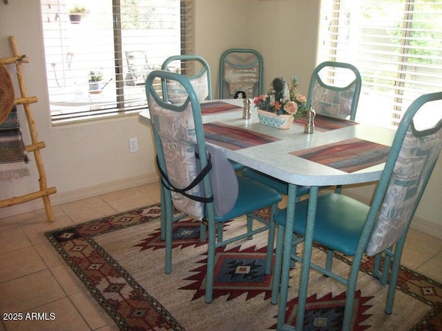 dining space with a healthy amount of sunlight and tile patterned floors