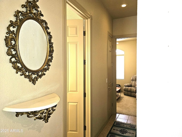 hall featuring tile patterned floors, carpet floors, and recessed lighting