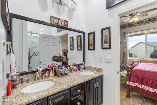 bathroom featuring ceiling fan, double vanity, ensuite bath, and a sink