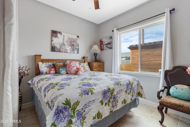 bedroom with ceiling fan and light tile patterned floors