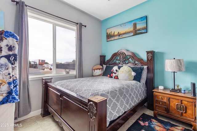 bedroom featuring light tile patterned floors and baseboards