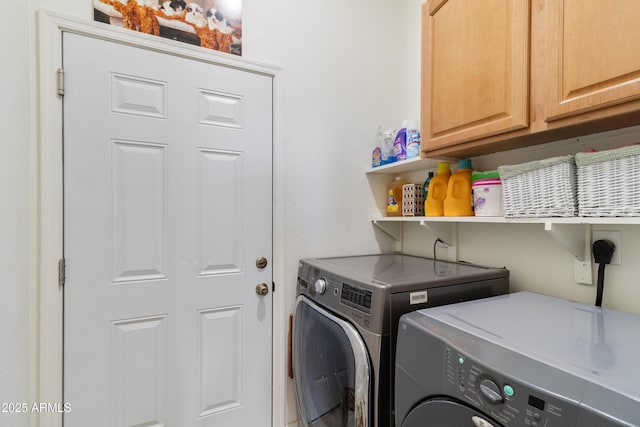 laundry area with separate washer and dryer and cabinet space