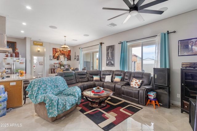 living area featuring beverage cooler, a wealth of natural light, visible vents, and recessed lighting