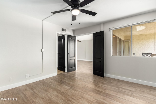 unfurnished bedroom with light wood-type flooring and ceiling fan