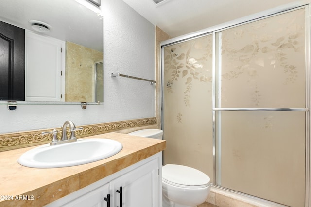 bathroom with vanity, toilet, and an enclosed shower