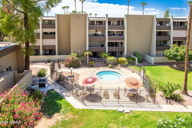 view of swimming pool featuring a hot tub and a patio