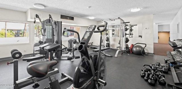 exercise room with a textured ceiling