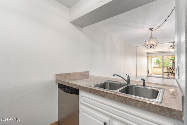 kitchen featuring hanging light fixtures, dishwasher, ceiling fan with notable chandelier, white cabinetry, and sink