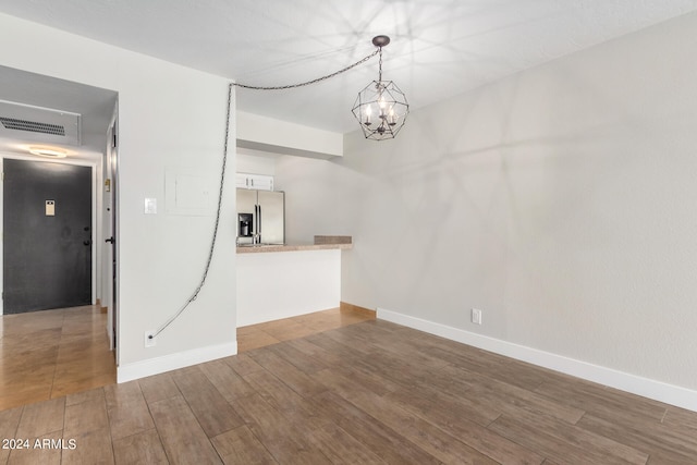 interior space featuring an inviting chandelier and hardwood / wood-style flooring