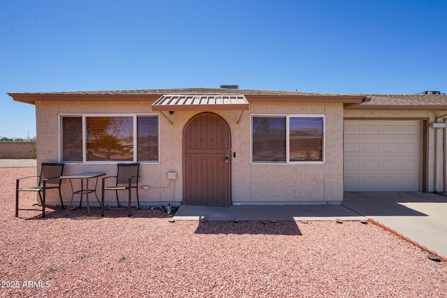 10018 N 97th Dr Unit A, Peoria, AZ 85345 - view of front facade featuring driveway, a garage, and stucco siding