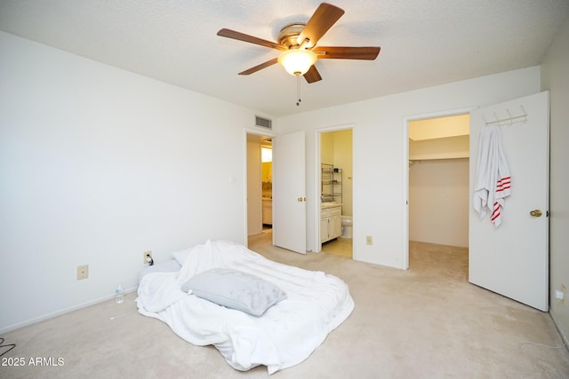 10018 N 97th Dr Unit A, Peoria, AZ 85345 - bedroom with light carpet, a spacious closet, a closet, and a ceiling fan
