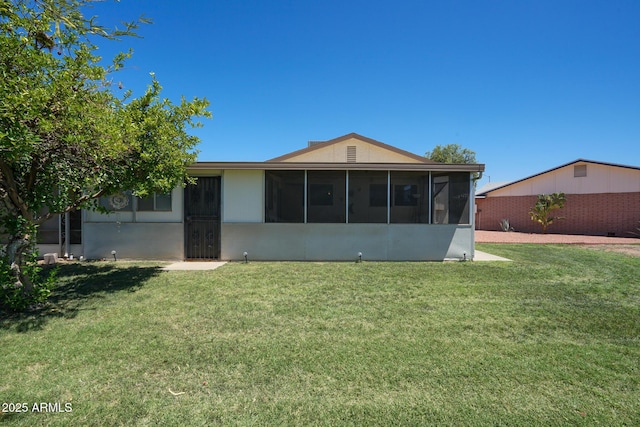 10018 N 97th Dr Unit A, Peoria, AZ 85345 - rear view of house with a sunroom and a lawn