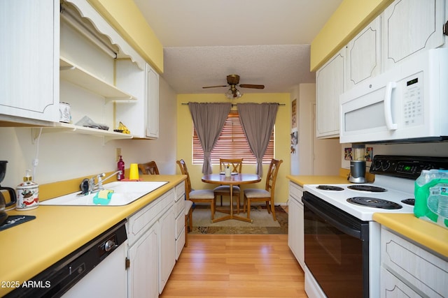 10018 N 97th Dr Unit A, Peoria, AZ 85345 - kitchen with white appliances, light wood-type flooring, light countertops, white cabinetry, and a textured ceiling