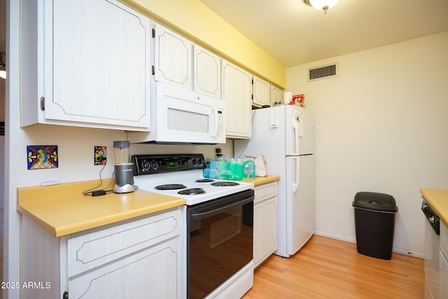 10018 N 97th Dr Unit A, Peoria, AZ 85345 - kitchen featuring white appliances, light wood-style floors, light countertops, and white cabinets