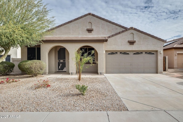 17562 W Agave Ct, Goodyear, AZ 85338 - mediterranean / spanish home featuring a garage, concrete driveway, and stucco siding