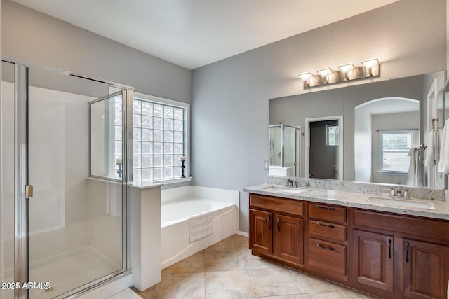 17562 W Agave Ct, Goodyear, AZ 85338 - full bath with a shower stall, double vanity, a garden tub, and tile patterned flooring