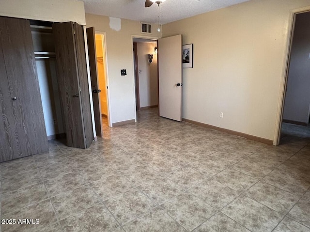 unfurnished bedroom with visible vents, ceiling fan, baseboards, and a closet