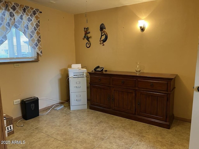 interior space featuring light tile patterned floors and baseboards