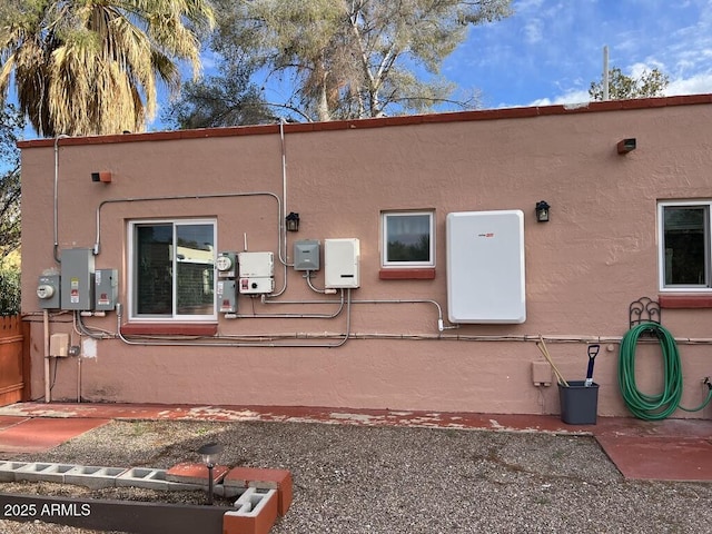 rear view of house with stucco siding