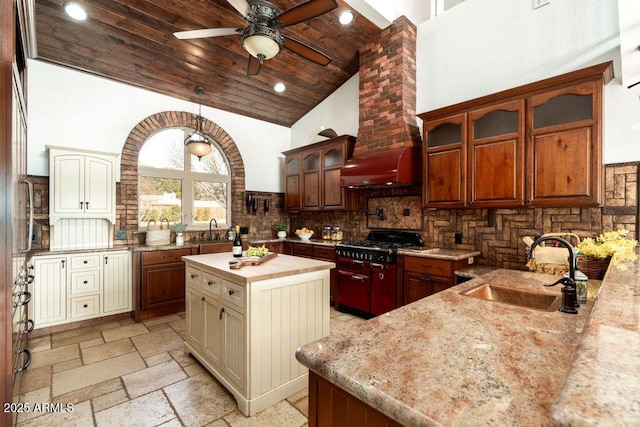 kitchen featuring cream cabinetry, sink, wood ceiling, and a center island