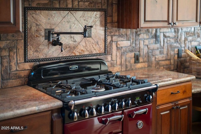 kitchen featuring tasteful backsplash and range with two ovens