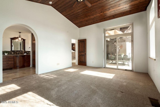 unfurnished bedroom with an inviting chandelier, high vaulted ceiling, light colored carpet, and wooden ceiling