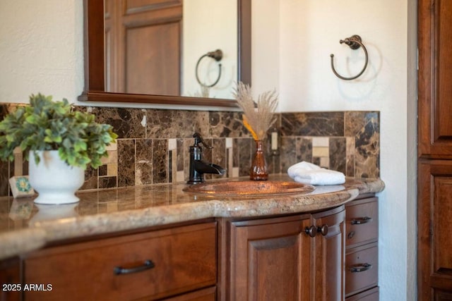 bar with light stone counters, sink, and backsplash