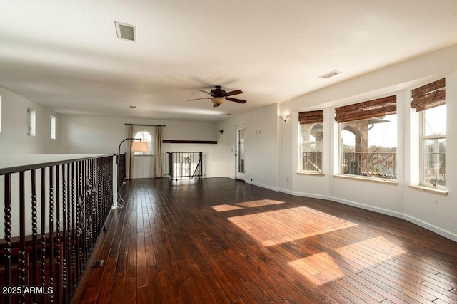 empty room featuring dark wood-type flooring and ceiling fan