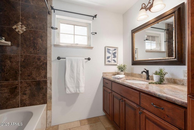 bathroom with tiled shower / bath and vanity