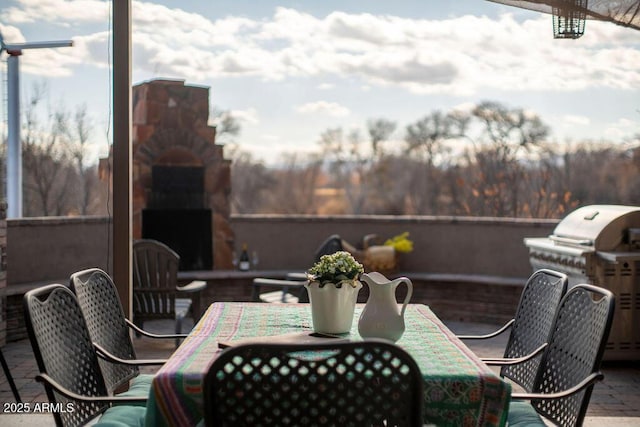 view of patio / terrace with grilling area and exterior fireplace