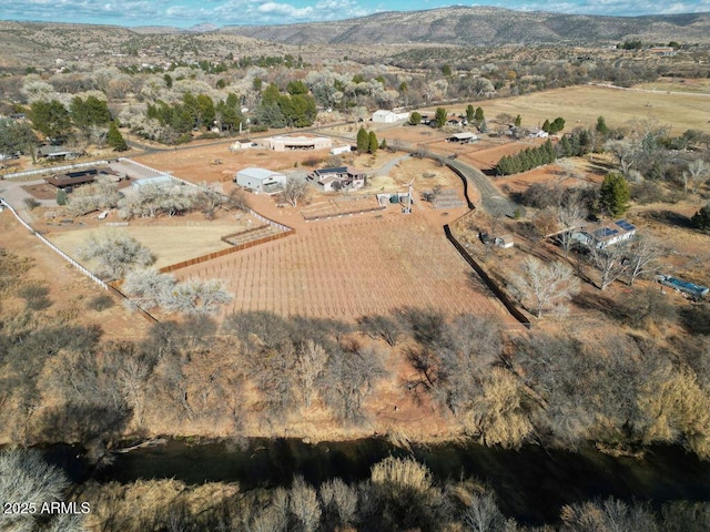 birds eye view of property featuring a mountain view and a rural view