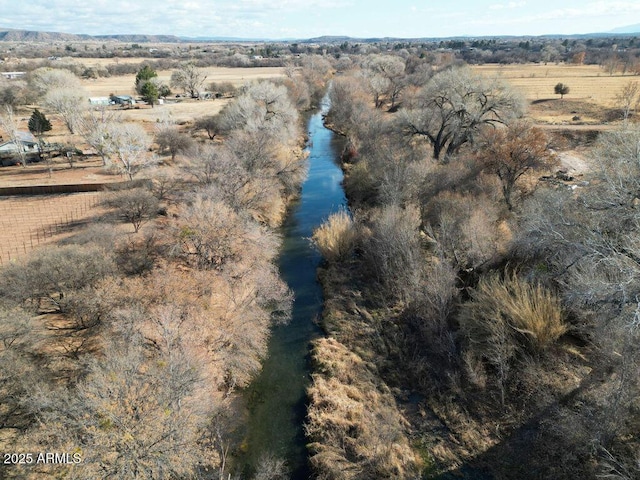 birds eye view of property featuring a water view and a rural view