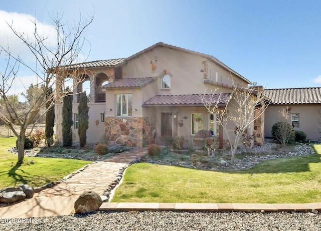 mediterranean / spanish-style house with a front yard