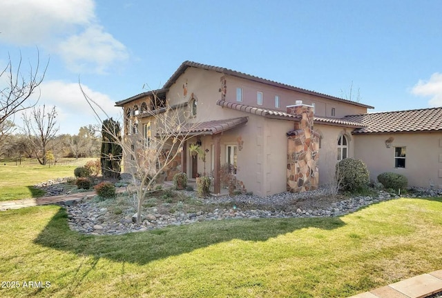 view of side of property with a lawn