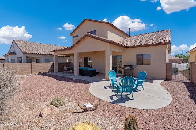 back of property with outdoor lounge area and a patio area