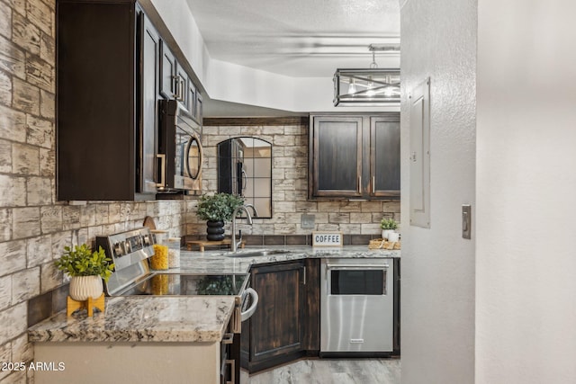 8787 E Mountain View Rd Unit 2100, Scottsdale, AZ 85258 - kitchen with appliances with stainless steel finishes, a sink, dark brown cabinetry, light stone counters, and tasteful backsplash