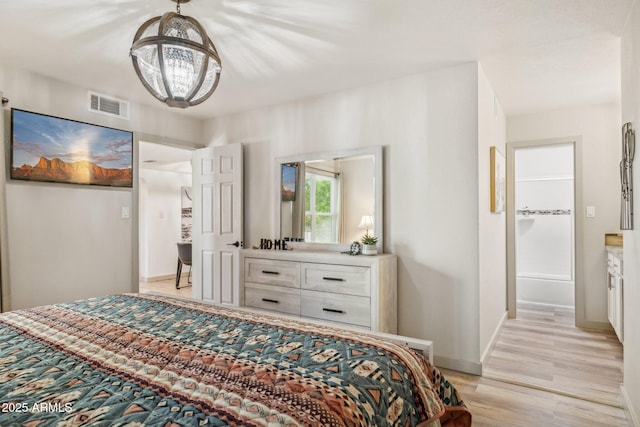 8787 E Mountain View Rd Unit 2100, Scottsdale, AZ 85258 - bedroom featuring light wood-style flooring, a chandelier, and baseboards