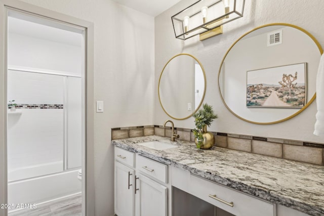 8787 E Mountain View Rd Unit 2100, Scottsdale, AZ 85258 - full bath featuring vanity, shower / bath combination with glass door, and wood finished floors