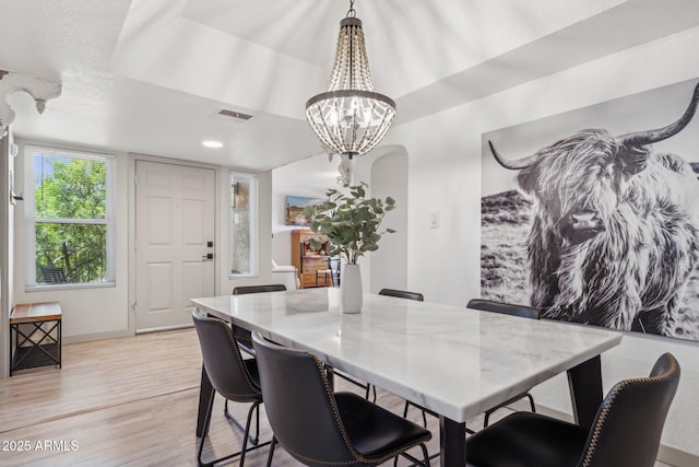 8787 E Mountain View Rd Unit 2100, Scottsdale, AZ 85258 - dining area featuring a chandelier, light wood finished floors, and baseboards