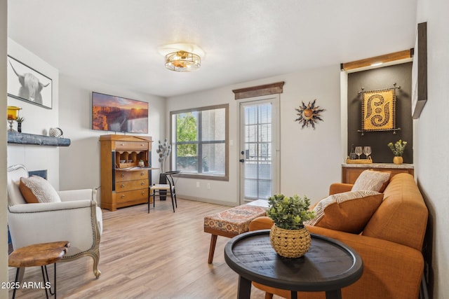 8787 E Mountain View Rd Unit 2100, Scottsdale, AZ 85258 - living room featuring light wood finished floors, a fireplace, and baseboards
