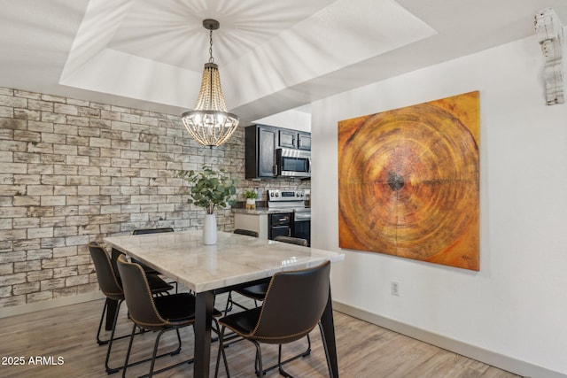 8787 E Mountain View Rd Unit 2100, Scottsdale, AZ 85258 - dining room featuring a chandelier, baseboards, and light wood finished floors
