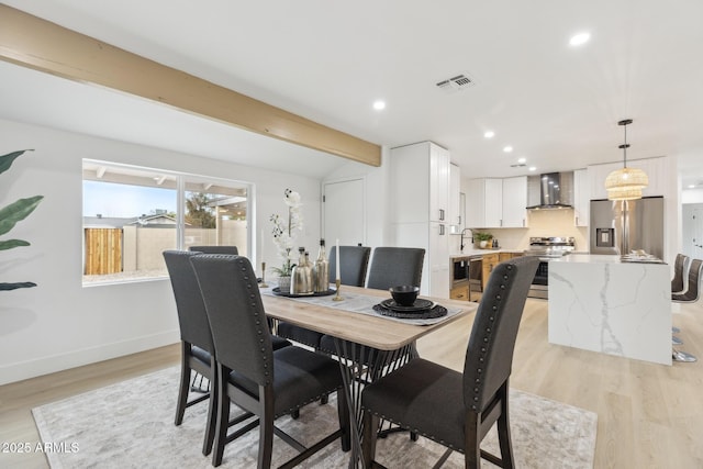 dining room with recessed lighting, visible vents, lofted ceiling with beams, light wood-style floors, and baseboards