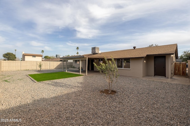 rear view of house with a patio and a fenced backyard