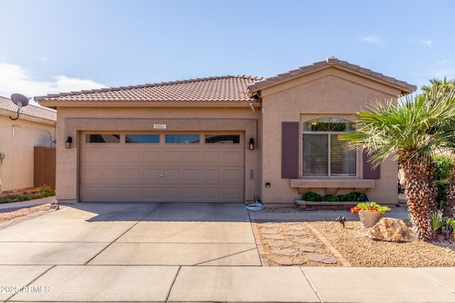 view of front facade featuring stucco siding, concrete driveway, an attached garage, and a tile roof